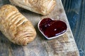 puff pastry with red strawberry jam on a wooden table Royalty Free Stock Photo