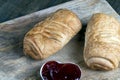 puff pastry with red strawberry jam on a wooden table Royalty Free Stock Photo