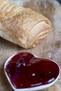 puff pastry with red strawberry jam on a wooden table Royalty Free Stock Photo