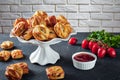 Puff pastry rolls with meat on a dish on stand Royalty Free Stock Photo