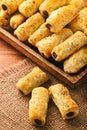 Puff pastry sausage rolls on brown wooden background.