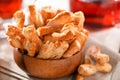 Puff pastry sticks cookies close-up in wooden bowl on table