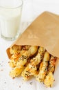 Puff Pastry Sticks in a Paper Bag with a Glass of Milk, copy space for your text Royalty Free Stock Photo