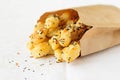Puff pastry sticks with sesame seeds in a paper bag, copy space for your text Royalty Free Stock Photo