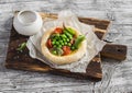 Puff pastry tartlet filled with egg, green peas and tomatoes. Royalty Free Stock Photo