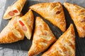 Puff pastry turnover with sausage, cheese and pepper close-up on a marble board. Horizontal top view Royalty Free Stock Photo