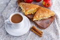 Puff pastry Turnovers apple cake dessert with whipped cream and hot coffee. Royalty Free Stock Photo