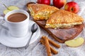 Puff pastry Turnovers apple cake dessert with whipped cream and hot coffee. Royalty Free Stock Photo