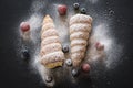 Puff pastry vanilla horns with fresh berries and powdered sugar, top view Royalty Free Stock Photo