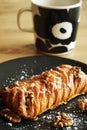 Puff pastry with walnuts and powdered sugar next to a cup of tea Royalty Free Stock Photo