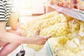 Puffcorn in hands buyer in store Royalty Free Stock Photo