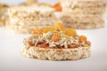 Puffed exploded wheat grains with peeled sunflower seeds, halva and raisins on a thin layer of apricot jam on