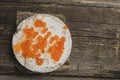 Rice crackers with smoked salmon spread on old wooden surface