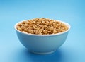 Puffed wheat cereal isolated on blue background Royalty Free Stock Photo