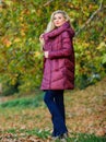 Puffer fashion concept. Professional stylist advice. Girl fashionable blonde walk in autumn park. Woman wear warm jacket