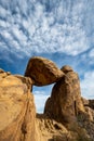 Puffy Cloud Wisps Over Balanced Rock Royalty Free Stock Photo