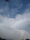 Puffy white cloud on blue sky. One white fluffy Cumulus cloud against a light blue clear sky close-up entirely.