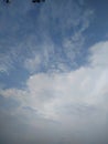 Puffy white cloud on blue sky. One white fluffy Cumulus cloud against a light blue clear sky close-up entirely. Royalty Free Stock Photo