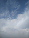 Puffy white cloud on blue sky. One white fluffy Cumulus cloud against a light blue clear sky close-up entirely.