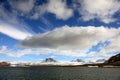 Puffy white clouds, blue sky, mountain peaks and glaciers in the arctic Svalbard Royalty Free Stock Photo