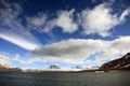 Puffy white clouds, blue sky, mountain peaks and glaciers in the arctic Svalbard Royalty Free Stock Photo