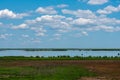 Puffy White Clouds Over a Marsh Royalty Free Stock Photo