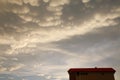 Puffy Yellow Clouds over Condo Royalty Free Stock Photo