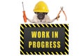 Pug dog wearing yellow constructor safety helmet,holding pliers and screwdriver, with warning sign saying work in progress