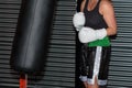 Pugilist Girl at Boxing Training with Black Punching Bag Royalty Free Stock Photo