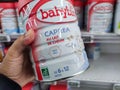 A consumer chooses a box of Babybio brand baby milk from the baby food section of a supermarket