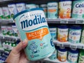 A consumer chooses a box of Modilac brand baby milk from the baby food section of a supermarket