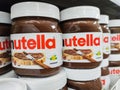 Focus on Nutella jars of hazelnut cream in french supermaket shelf. Nutella is a brand of products made in Italy by Ferrero