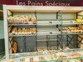 Multiple varieties of bread display for sell in the bakery section of a supermarket