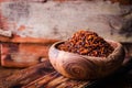 Pul biber - crushed red chili pepper in vintage bowl on wooden background. Selective focus. Toned image. Turkish cuisine Royalty Free Stock Photo