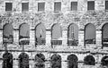 Pula Arena and cranes in cargo port, colorless