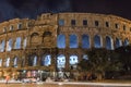 The Pula Arena Is Hosting A Live Concert In Croatia. Ancient Roman Amphitheatre. Smoke And Light Show Coming Out Of It