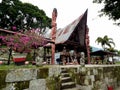 House with totens and stone figures at Huta Siallagan Ancient Batak Village on Lake Toba, Pulau Samosir. Indonesia