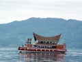 One of the ferries with the typical decoration of the area crossing Lake Toba