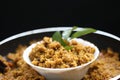 Puliyogare rice in the cooking pan with bowl, yellow color indian rice