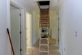 Pull down folding attic ladder stairs in small hallway