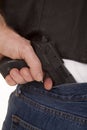 Pull gun out of pants close Royalty Free Stock Photo