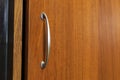 Pull knob in arch style on cabinet door. frosted silver metallic