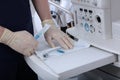 Pull-out panel on the ventilator to accommodate medical devices. Sterile sealed bag with tracheostomy tube. Preparing Royalty Free Stock Photo