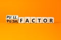 Pull or push factor symbol. Concept word Pull factor and Push factor on wooden cubes. Beautiful orange table orange background. Royalty Free Stock Photo