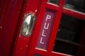 Pull sign on old telephone box Royalty Free Stock Photo