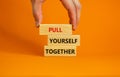 Pull yourself together symbol. Wooden blocks with words `Pull yourself together`. Beautiful orange background. Copy space.