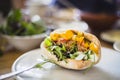 Pulled chicken in homemade bread with arugula salad, mango, tomato and yogurt dressing Royalty Free Stock Photo