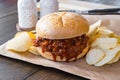 Pulled pork barbecue sandwich with potato chips