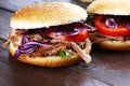 Pulled pork sandwiches with BBQ sauce, cabbage and tomato on tab Royalty Free Stock Photo