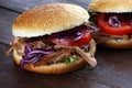 Pulled pork sandwiches with BBQ sauce, cabbage and tomato on tab Royalty Free Stock Photo